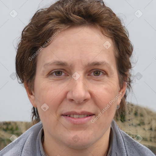 Joyful white adult female with short  brown hair and grey eyes