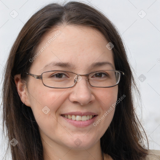 Joyful white adult female with long  brown hair and grey eyes