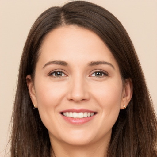 Joyful white young-adult female with long  brown hair and brown eyes