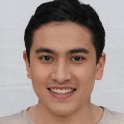 Joyful asian young-adult male with short  brown hair and brown eyes