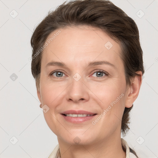 Joyful white adult female with short  brown hair and grey eyes