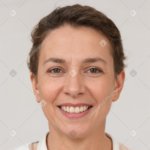 Joyful white adult female with short  brown hair and brown eyes