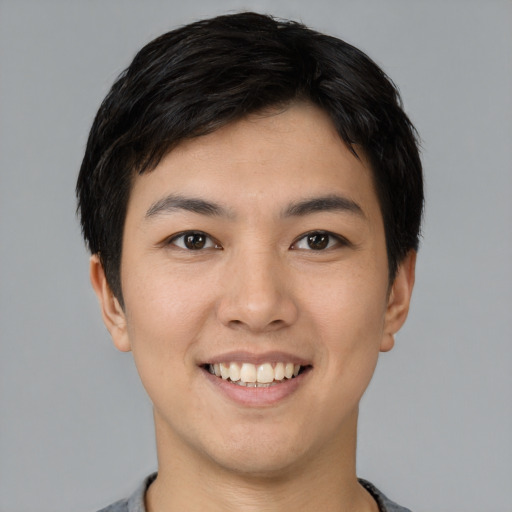 Joyful asian young-adult male with short  black hair and brown eyes