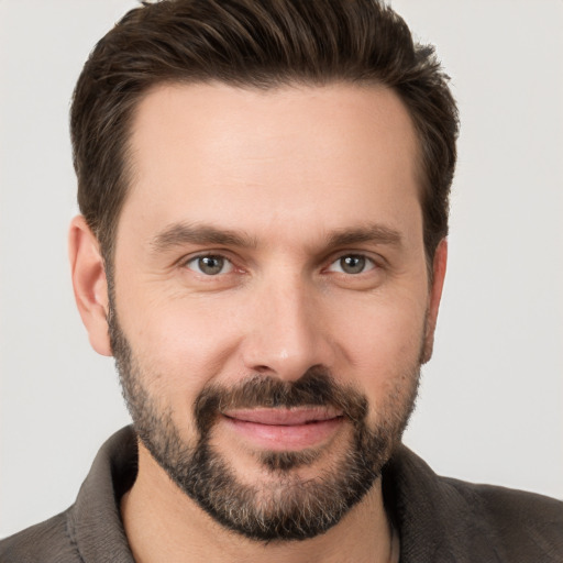 Joyful white young-adult male with short  brown hair and brown eyes