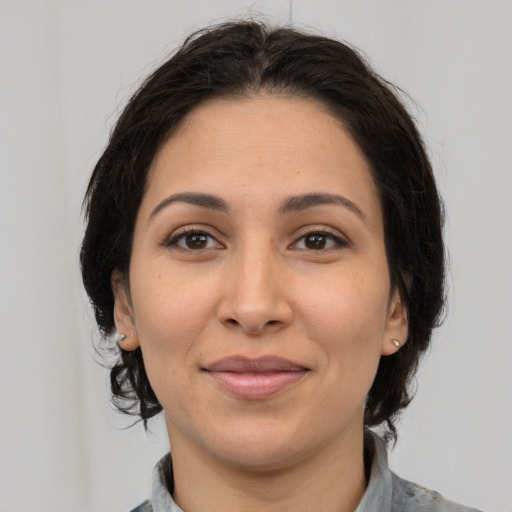 Joyful white adult female with medium  brown hair and brown eyes