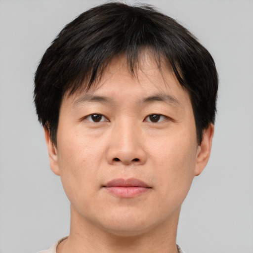 Neutral asian adult male with short  brown hair and brown eyes