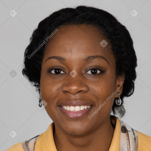 Joyful black young-adult female with short  black hair and brown eyes