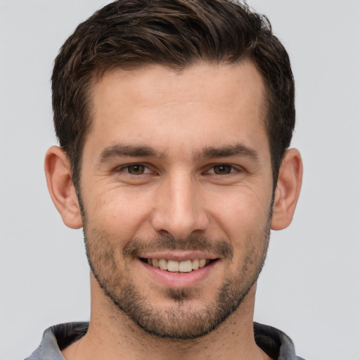 Joyful white young-adult male with short  brown hair and brown eyes