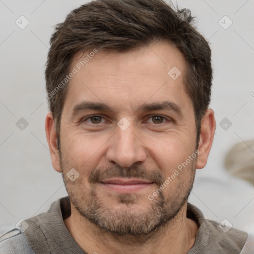 Joyful white adult male with short  brown hair and brown eyes