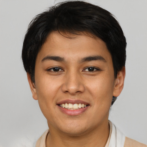 Joyful asian young-adult male with short  brown hair and brown eyes