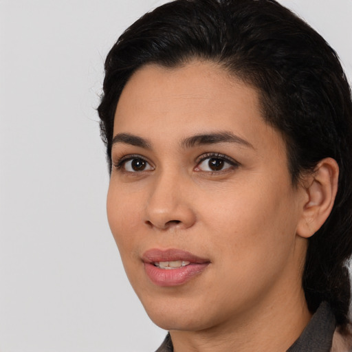 Joyful latino young-adult female with medium  black hair and brown eyes