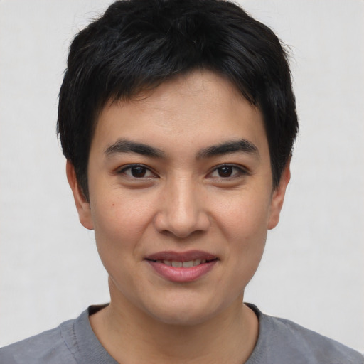 Joyful asian young-adult male with short  black hair and brown eyes