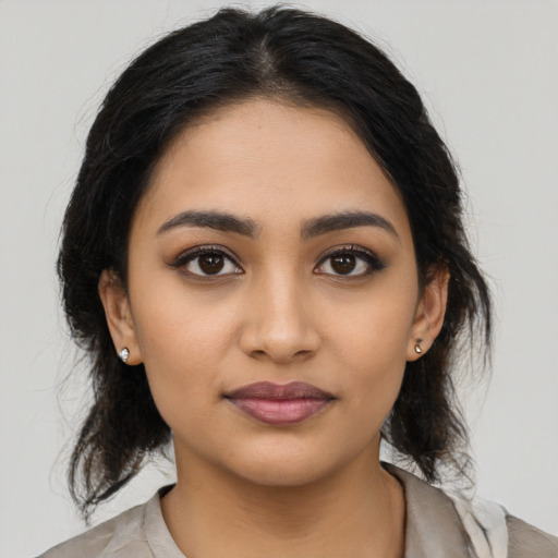 Joyful latino young-adult female with medium  black hair and brown eyes
