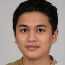 Joyful asian young-adult male with short  black hair and brown eyes