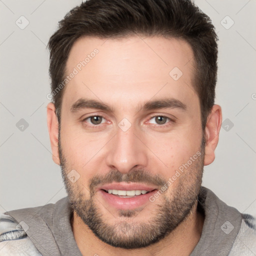 Joyful white young-adult male with short  brown hair and brown eyes