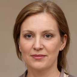 Joyful white adult female with medium  brown hair and grey eyes