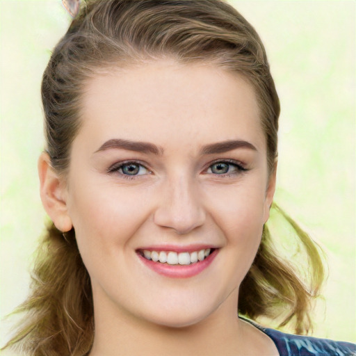 Joyful white young-adult female with medium  brown hair and green eyes