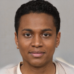 Joyful black young-adult male with short  black hair and brown eyes