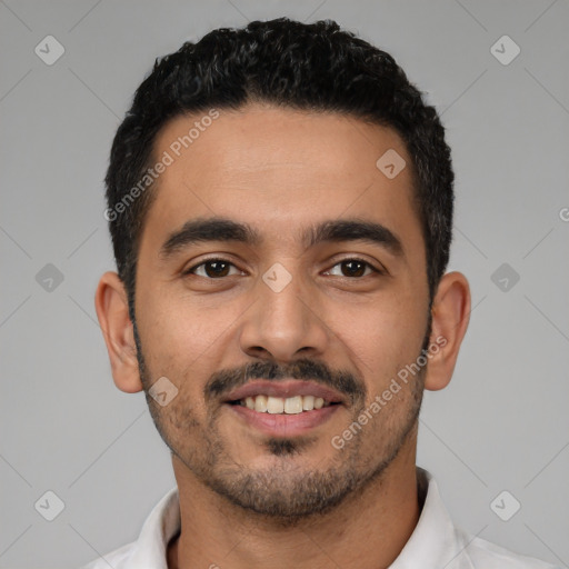 Joyful latino young-adult male with short  black hair and brown eyes