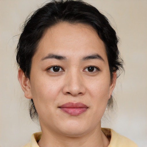 Joyful asian young-adult female with medium  brown hair and brown eyes