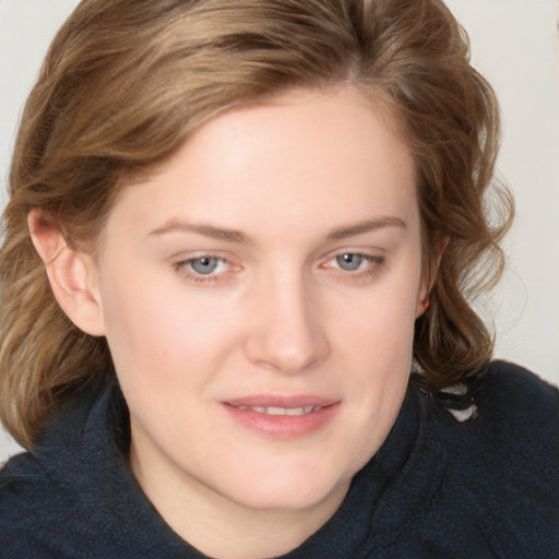 Joyful white young-adult female with medium  brown hair and blue eyes