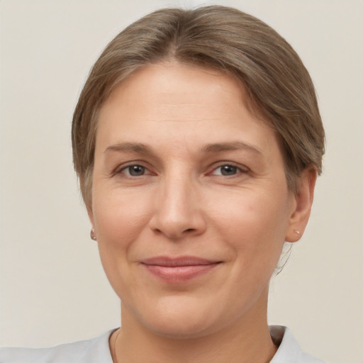 Joyful white adult female with short  brown hair and brown eyes