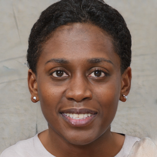 Joyful black young-adult female with short  brown hair and brown eyes