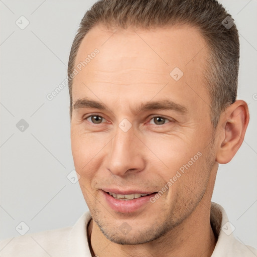 Joyful white adult male with short  brown hair and brown eyes