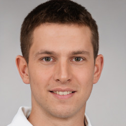 Joyful white young-adult male with short  brown hair and brown eyes