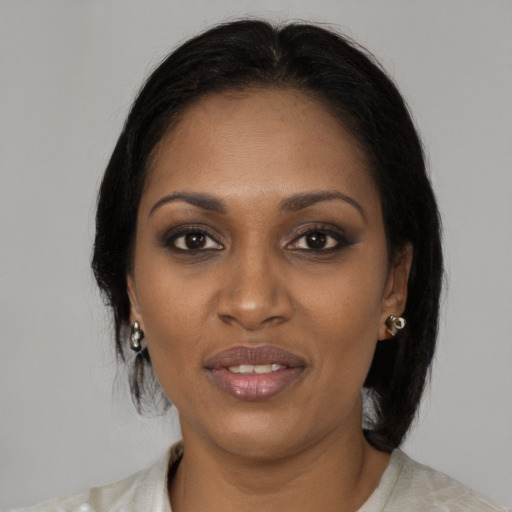 Joyful black young-adult female with medium  brown hair and brown eyes