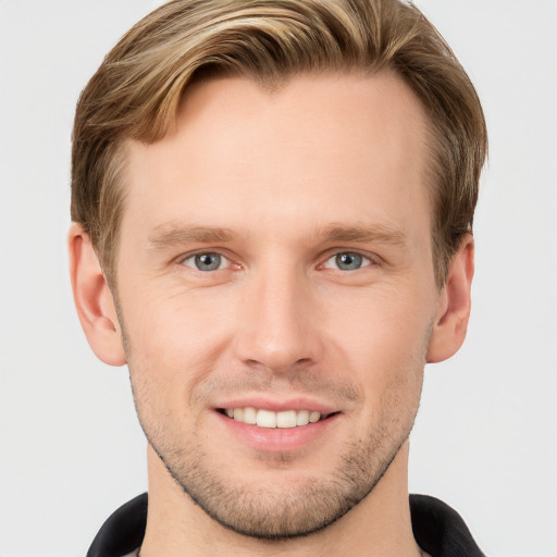 Joyful white young-adult male with short  brown hair and grey eyes