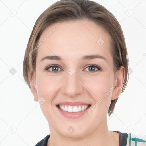 Joyful white young-adult female with medium  brown hair and grey eyes