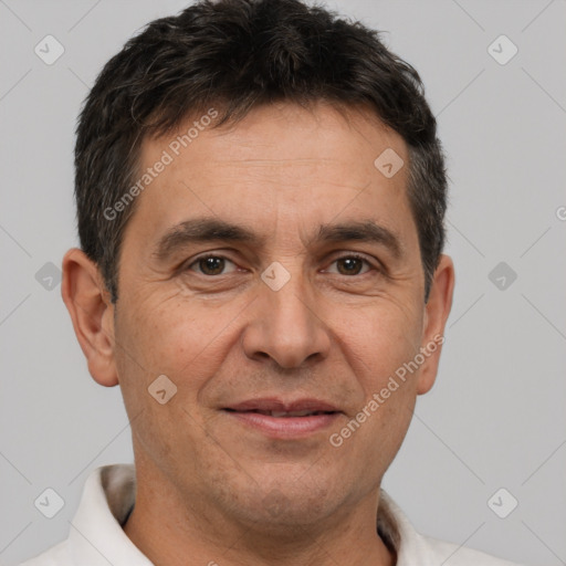 Joyful white adult male with short  brown hair and brown eyes