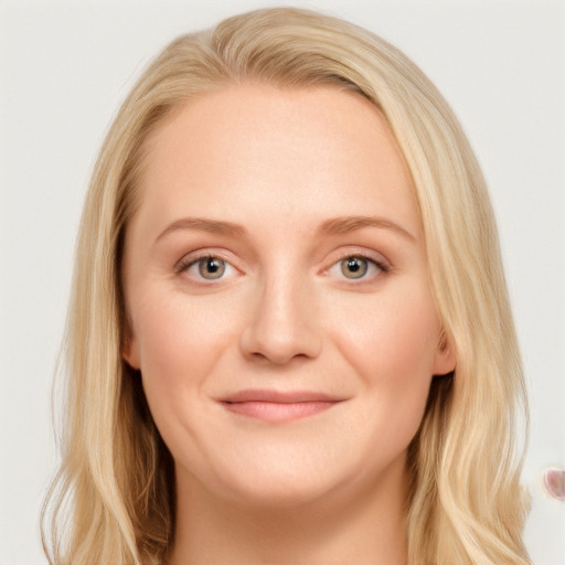 Joyful white young-adult female with long  brown hair and blue eyes