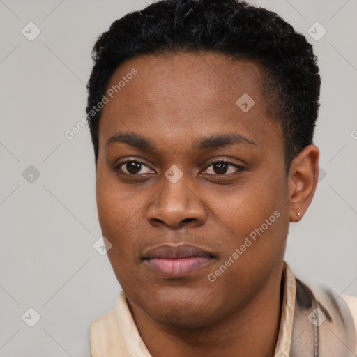 Joyful black young-adult female with short  black hair and brown eyes