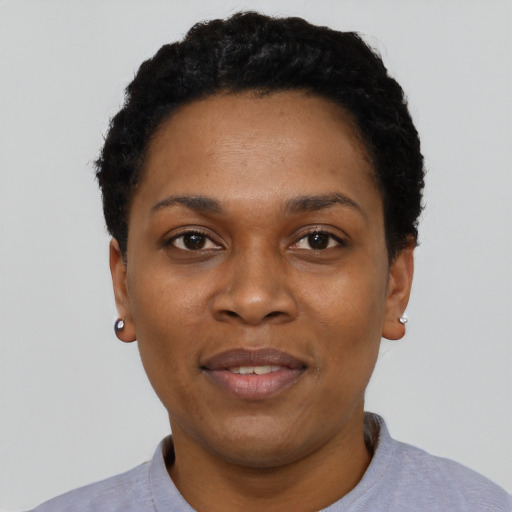 Joyful black adult female with short  black hair and brown eyes