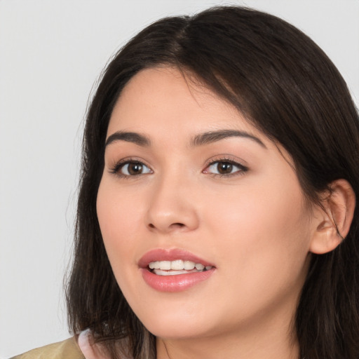 Joyful white young-adult female with long  brown hair and brown eyes