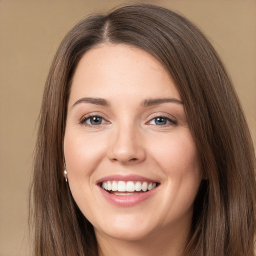 Joyful white young-adult female with long  brown hair and brown eyes