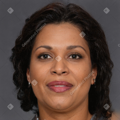 Joyful latino adult female with medium  brown hair and brown eyes