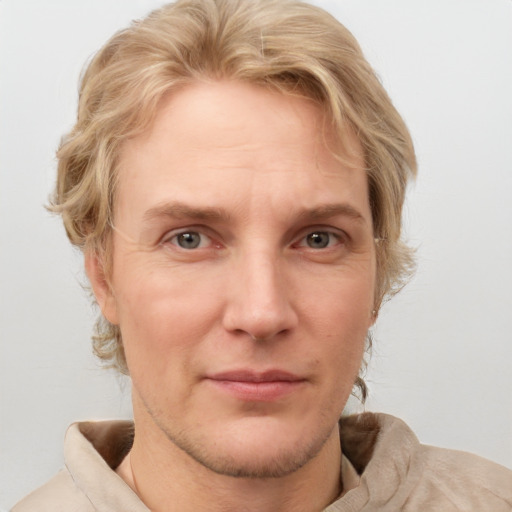 Joyful white adult male with medium  brown hair and blue eyes