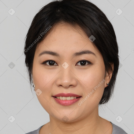 Joyful asian young-adult female with medium  black hair and brown eyes