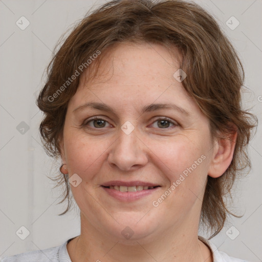 Joyful white adult female with medium  brown hair and brown eyes