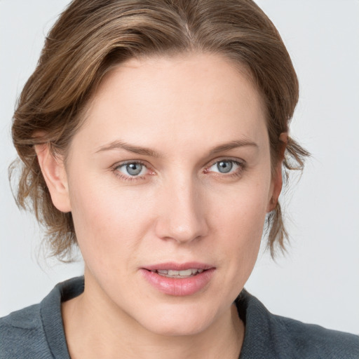 Joyful white young-adult female with medium  brown hair and blue eyes