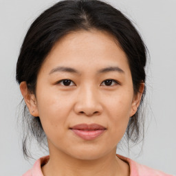 Joyful asian young-adult female with medium  brown hair and brown eyes