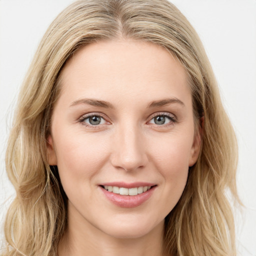 Joyful white young-adult female with long  brown hair and blue eyes