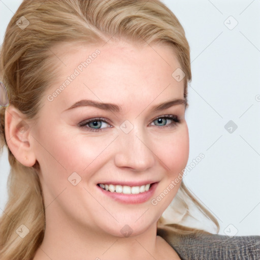 Joyful white young-adult female with long  brown hair and blue eyes