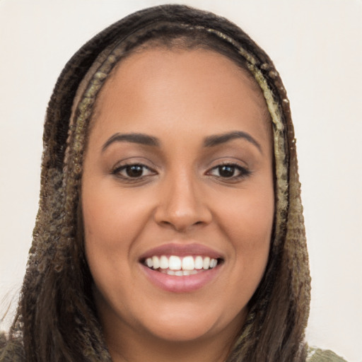 Joyful latino young-adult female with long  brown hair and brown eyes