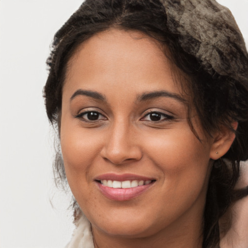 Joyful latino young-adult female with long  brown hair and brown eyes