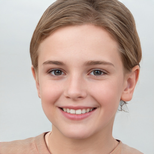 Joyful white child female with short  brown hair and grey eyes