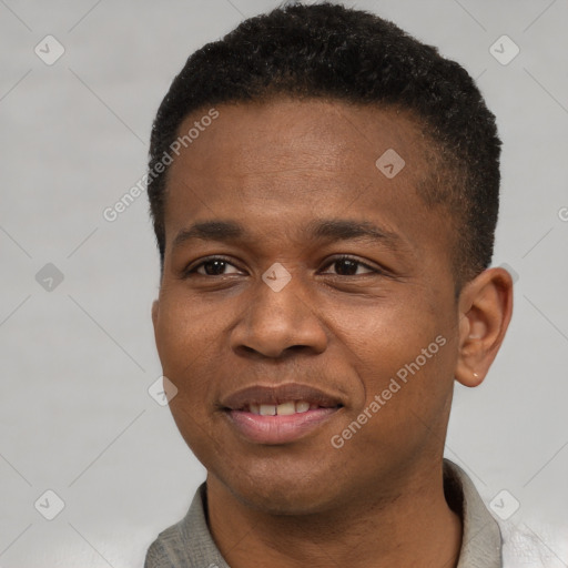 Joyful black young-adult male with short  black hair and brown eyes